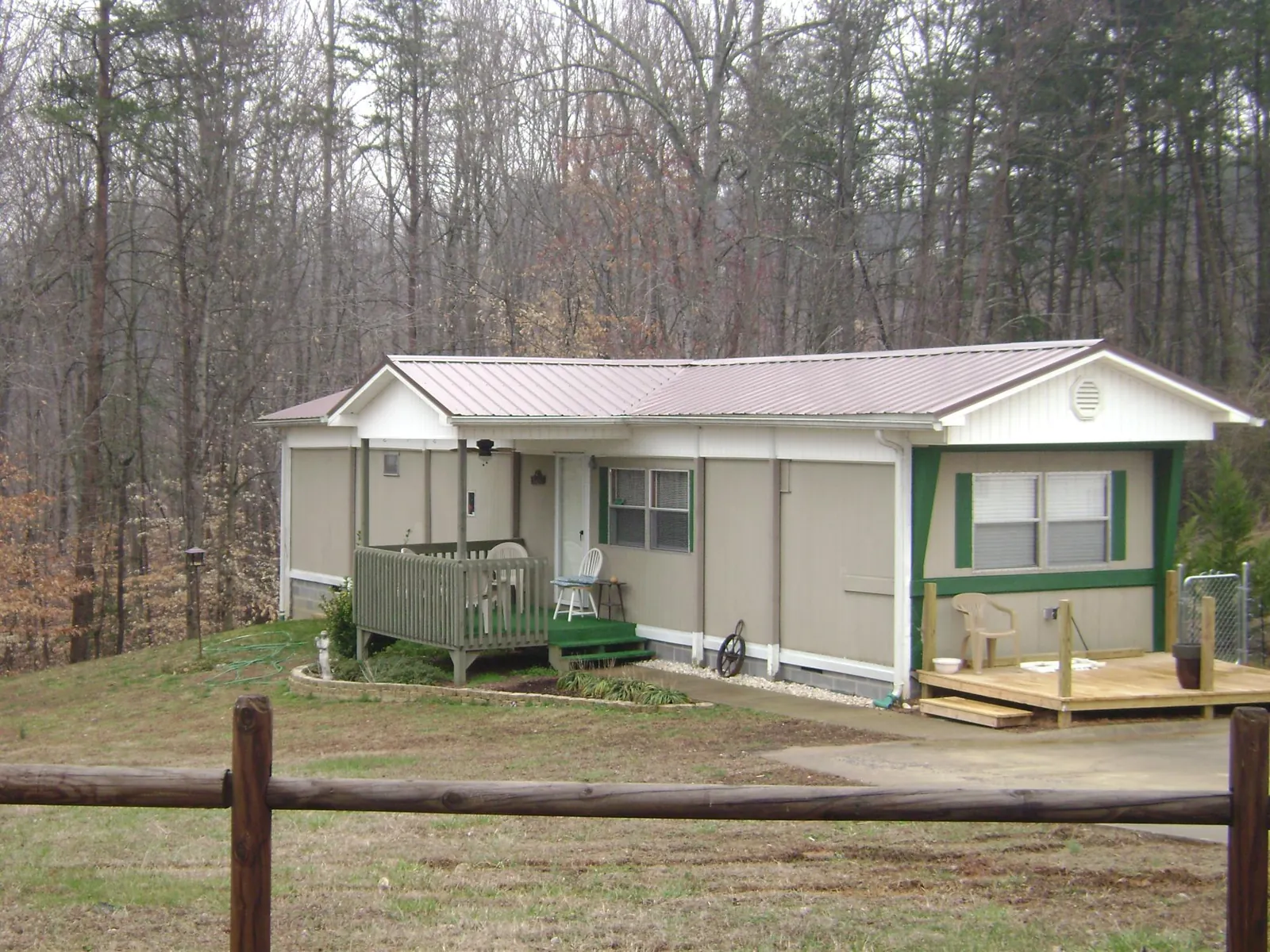 Mauve metal roof on a manufactured home with a new front deck in Calder